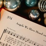 christmas carol sheet with festive ornaments